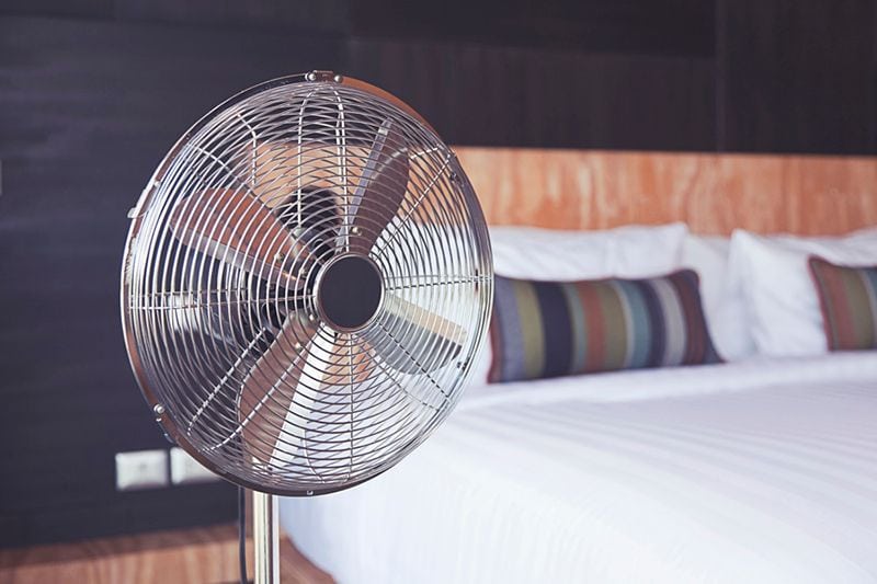 A focused image of a fan in a bedroom. Why Air Duct Cleaning Is Important.
