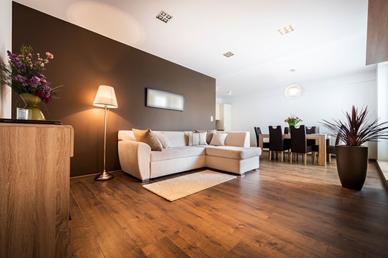 living room and dining room, white white and black furniture. There is dark wood flooring.